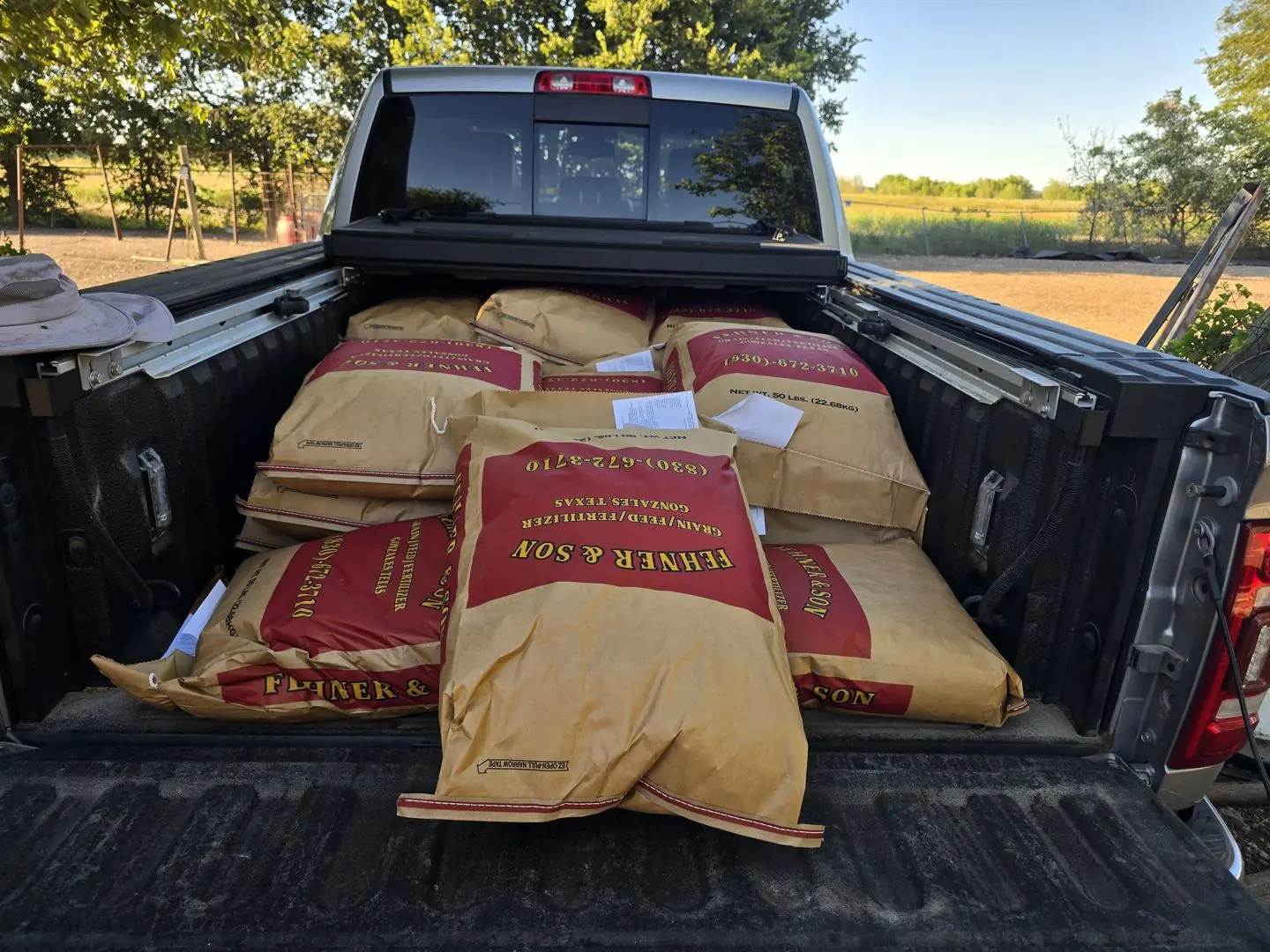 Bags of feed loaded in a pickup bed for JDFHR